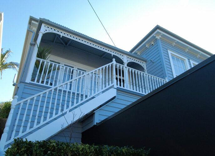 Villa after painting with white handrails and dark plaster garage