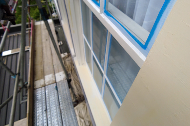 Wooden windows with blue tape and filler