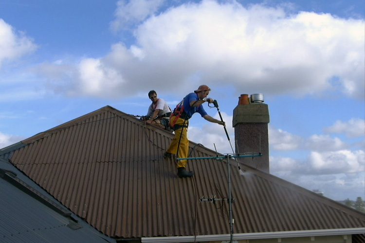 waterblasting iron roof with harness