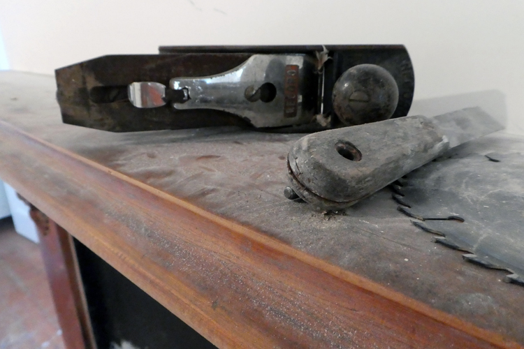 tools on top of a dusty fireplace