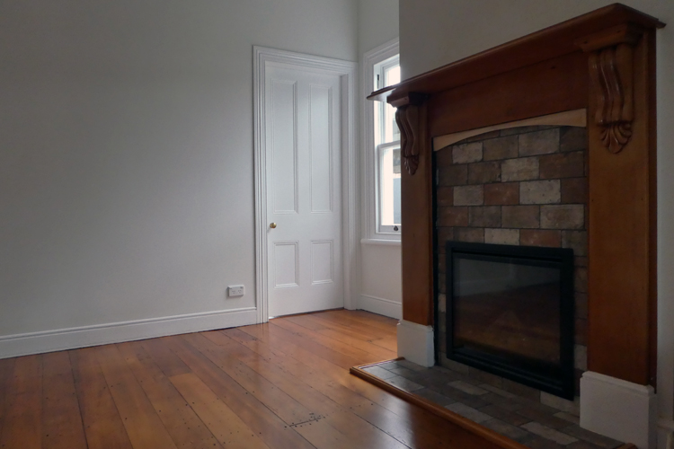 white door with wooden floors and wooden fireplace
