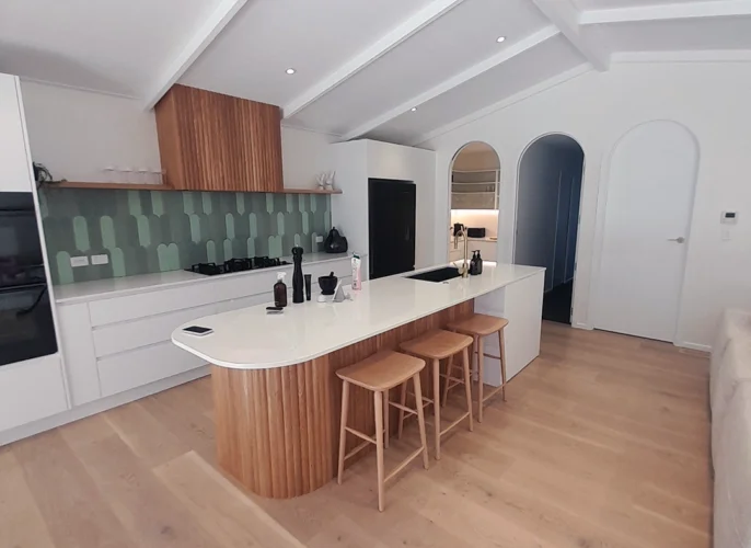 A kitchen with a bar and counter, providing a functional and stylish space for cooking and dining.